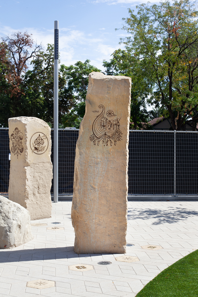 A sandstone pillar with an etching of Scandinavian motifs and symbols.