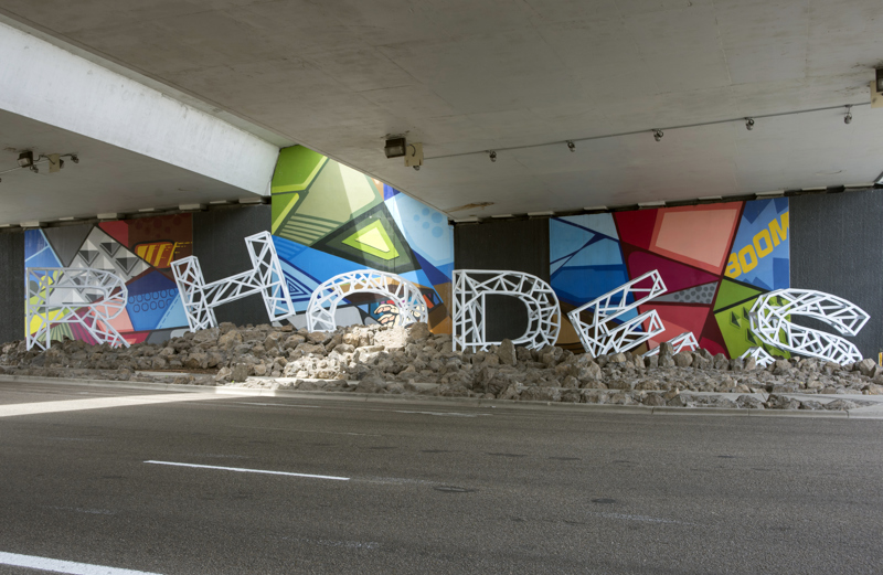 A large installation of the name "Rhodes" made from white painted steel. 