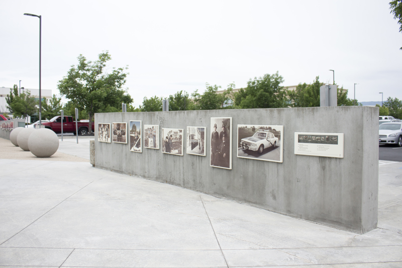 A concrete wall with a series of baked enamel images of professional first responders from Boise's history.