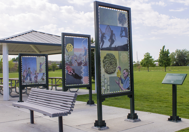 Three double-sided paintings framed and mounted on two-legged stands painted green. Each painting depicts symbols of science and geometry with objects of nature or playful activities that exhibit similar patterns. 