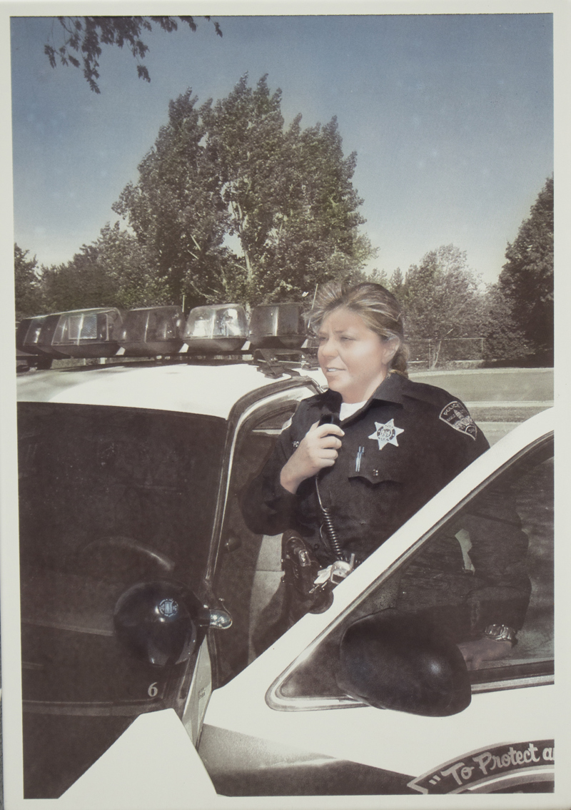 An image of Officer Tonya Brown speaking into her car radio in 2004.