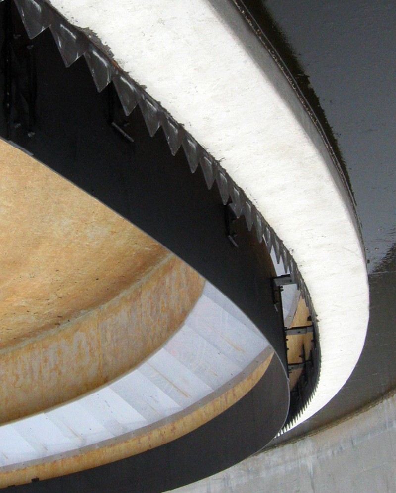 An upside-down image of a curved water separator or clarifier mean to remove unwanted materials from water.