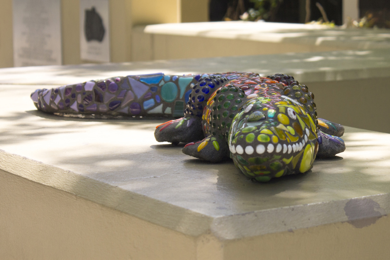 A glass mosaic sculpture of an alligator.