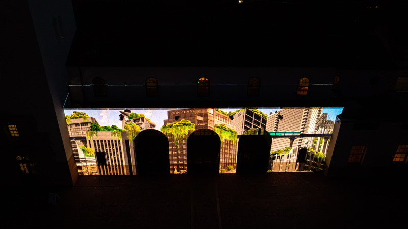 An ariel photograph of the Boise Depot at sunset. On the front of the building is a bright animated projection.