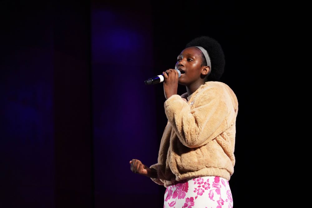 A woman singing into a microphone.