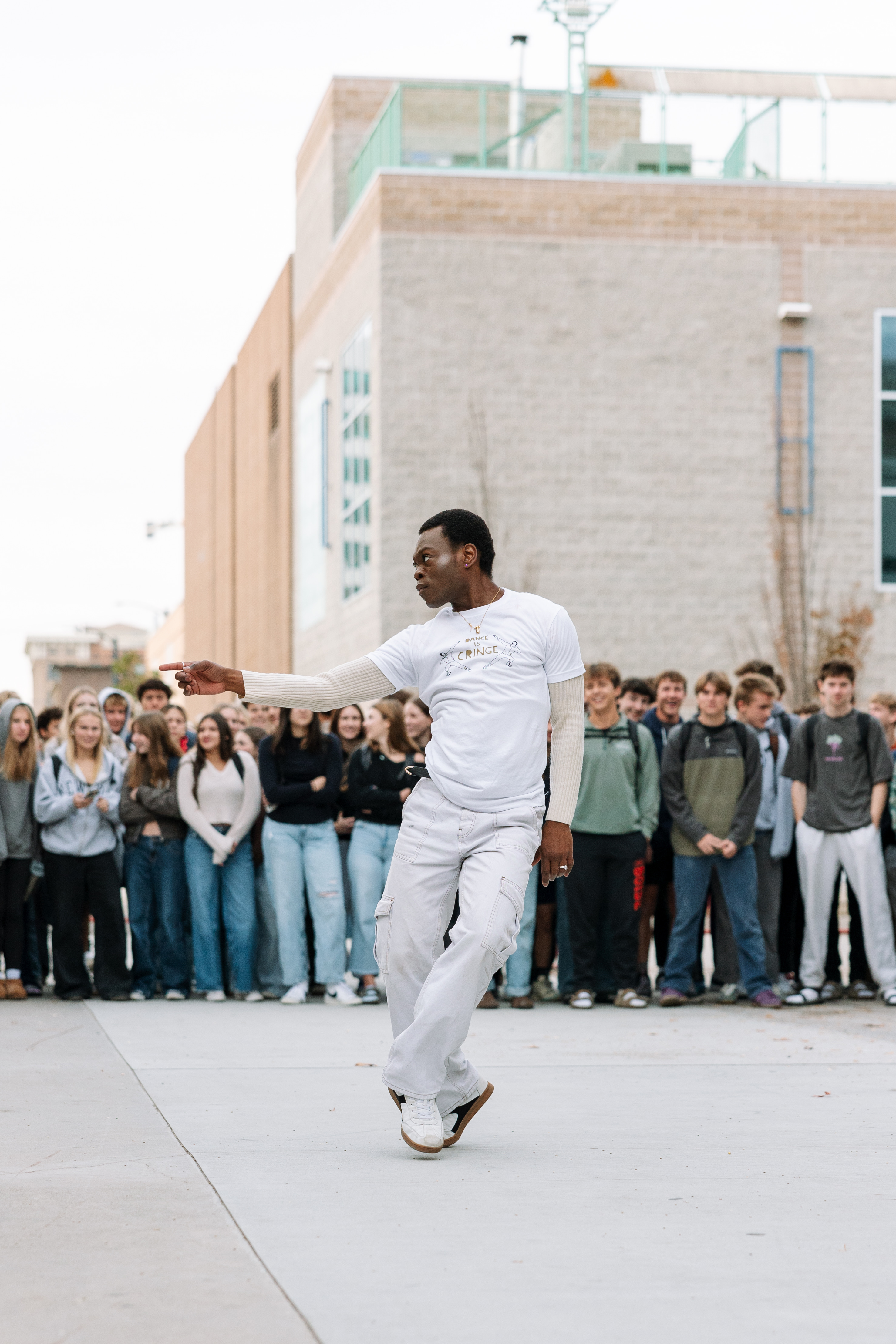 Man dancing with crowd watching in the background.