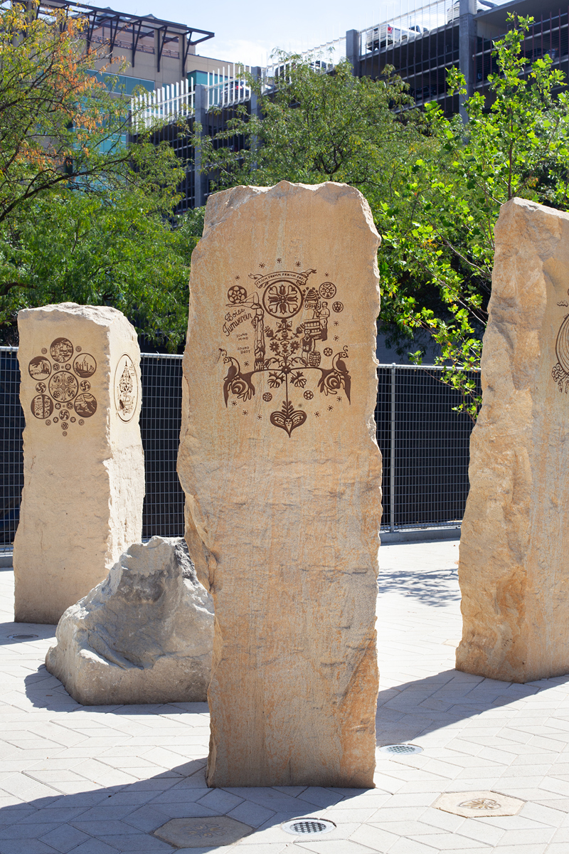 A sandstone pillar with an etching of German motifs and symbols.