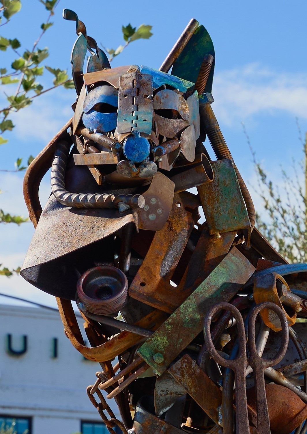 Found materials sculpture of adult and baby coyote.