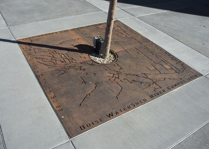 A steel tree grate cut to depict a map locating all the sewer lines in Boise.