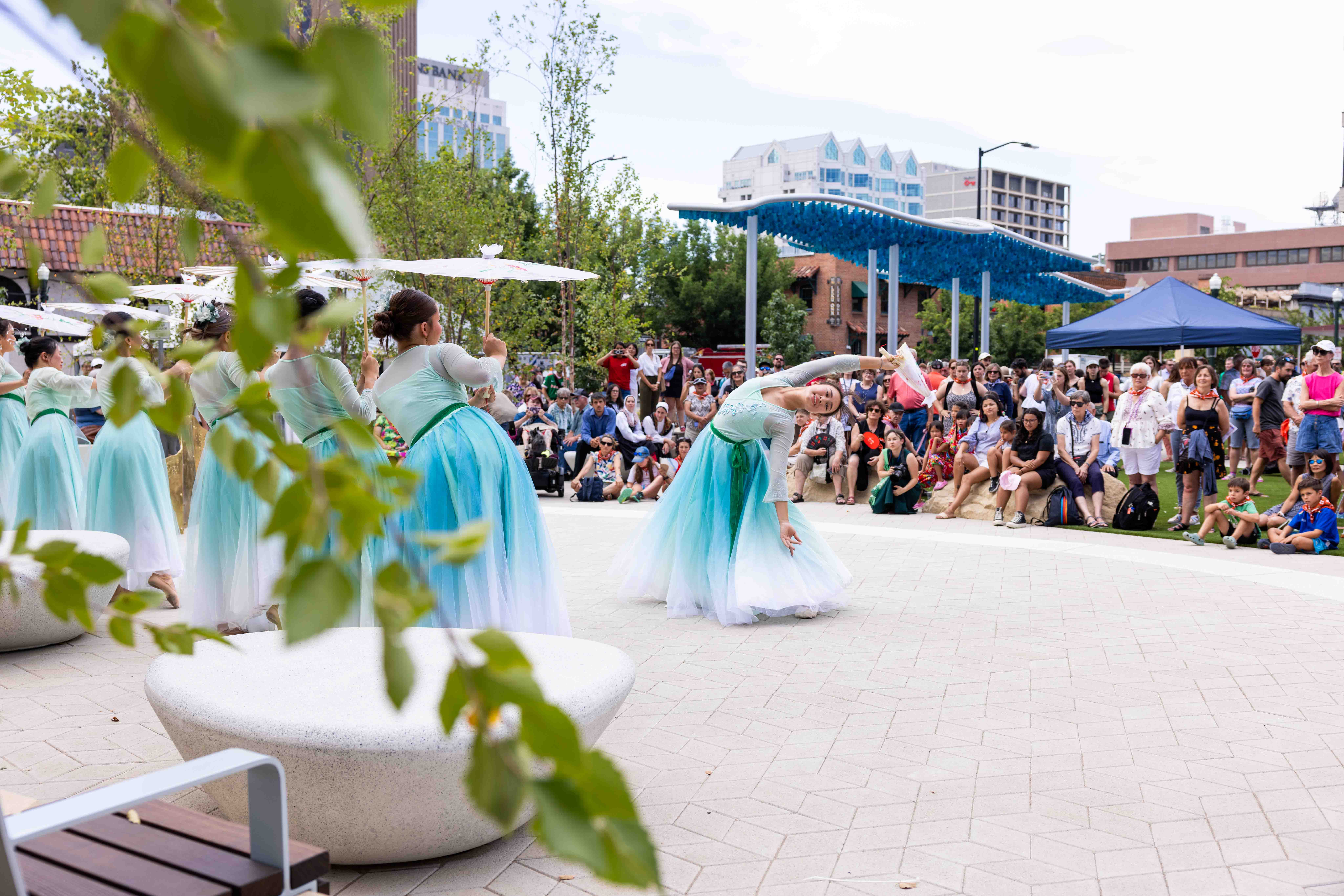 Dancers mirror movement of Skyriver art installation at Kaixo Corner.