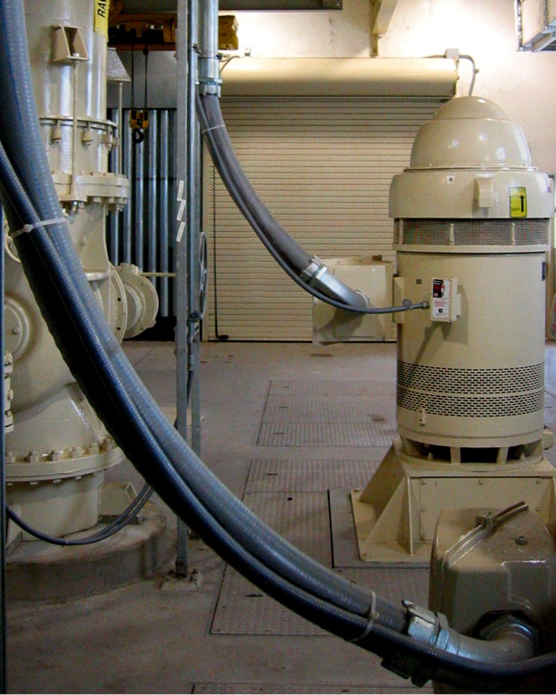 The interior of a treatment center with cylindrical machines that have tubes extending out from them. In the background is a rollup garage door.